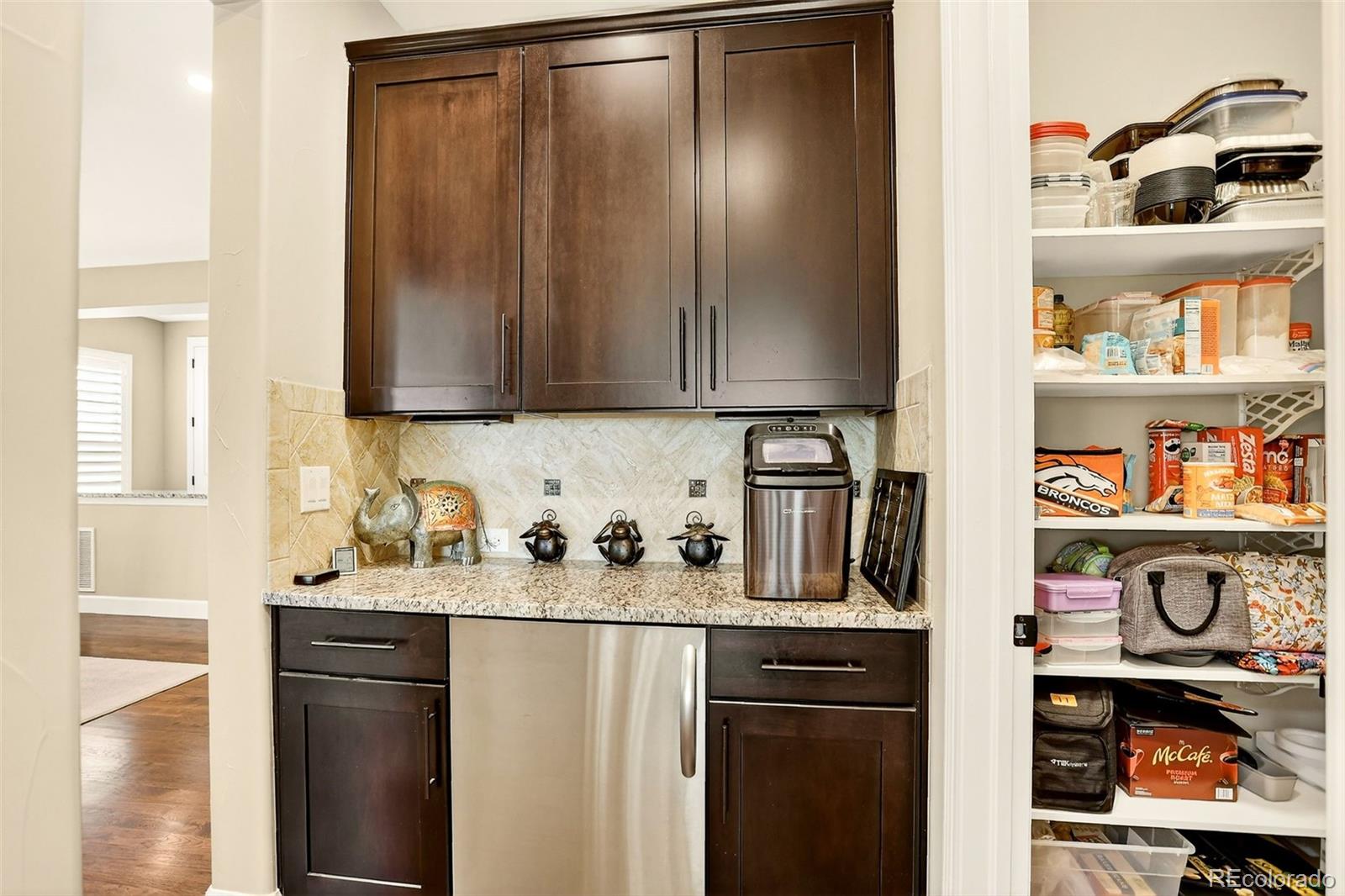 10544 Soulmark Way Highlands Ranch, CO 80126 - Photo 17 of 50 a kitchen with stainless steel appliances granite countertop a refrigerator and a sink