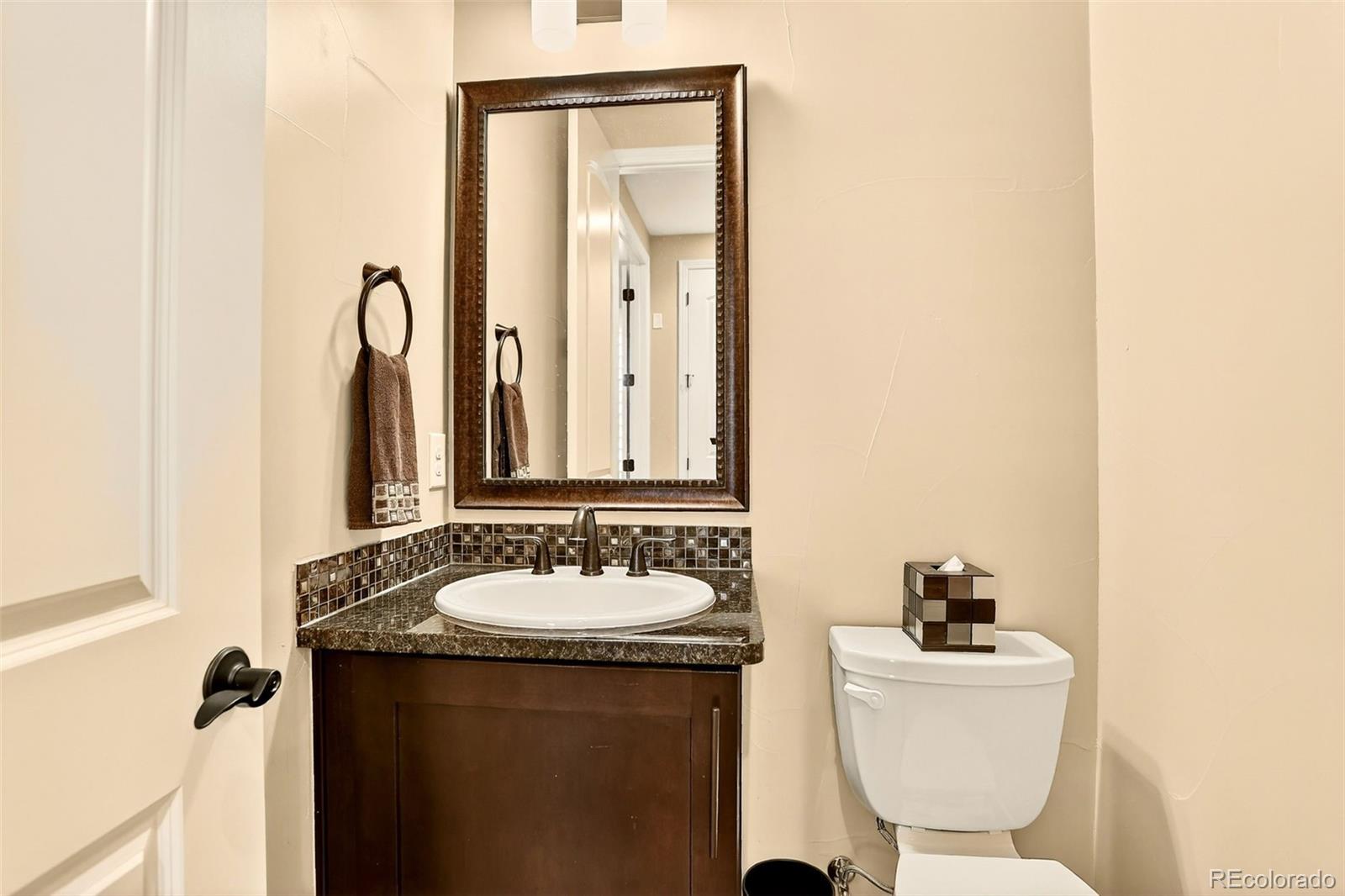 10544 Soulmark Way Highlands Ranch, CO 80126 - Photo 19 of 50 a bathroom with a sink and a mirror