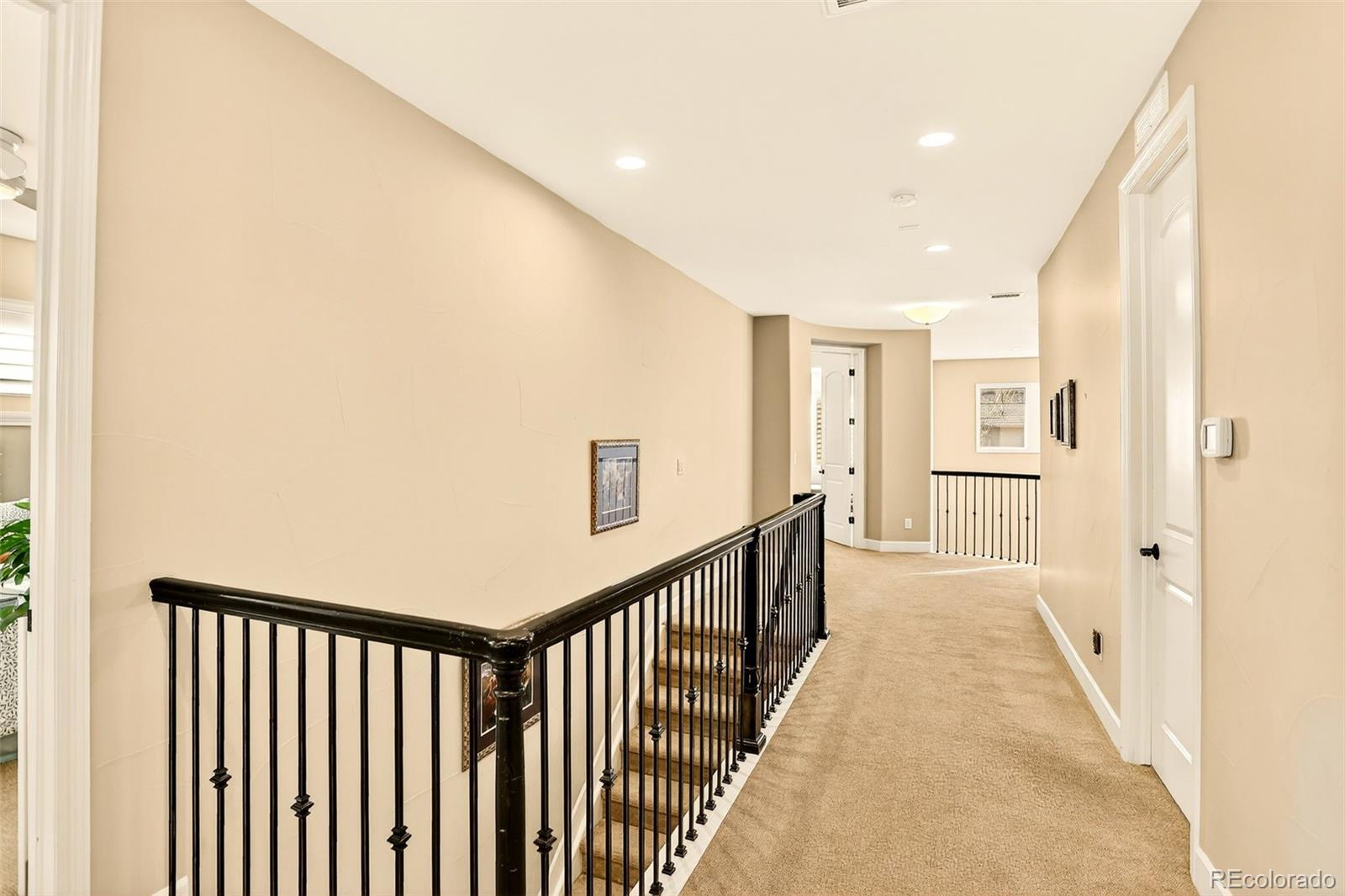 10544 Soulmark Way Highlands Ranch, CO 80126 - Photo 21 of 50 a view of a hallway with wooden floor