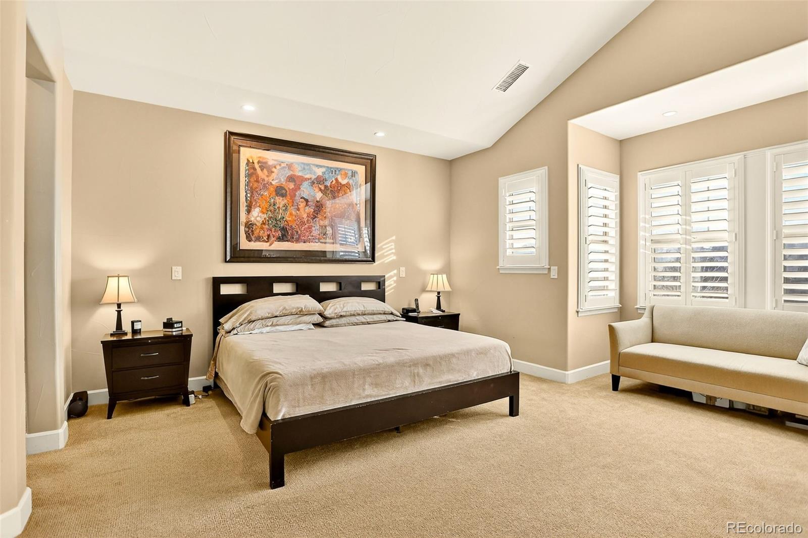 10544 Soulmark Way Highlands Ranch, CO 80126 - Photo 24 of 50 a spacious bedroom with a bed and a couch