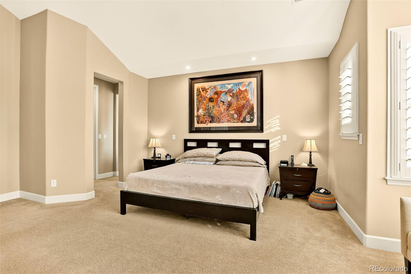10544 Soulmark Way Highlands Ranch, CO 80126 - Photo 25 of 50 a bedroom with a bed and a painting on the wall