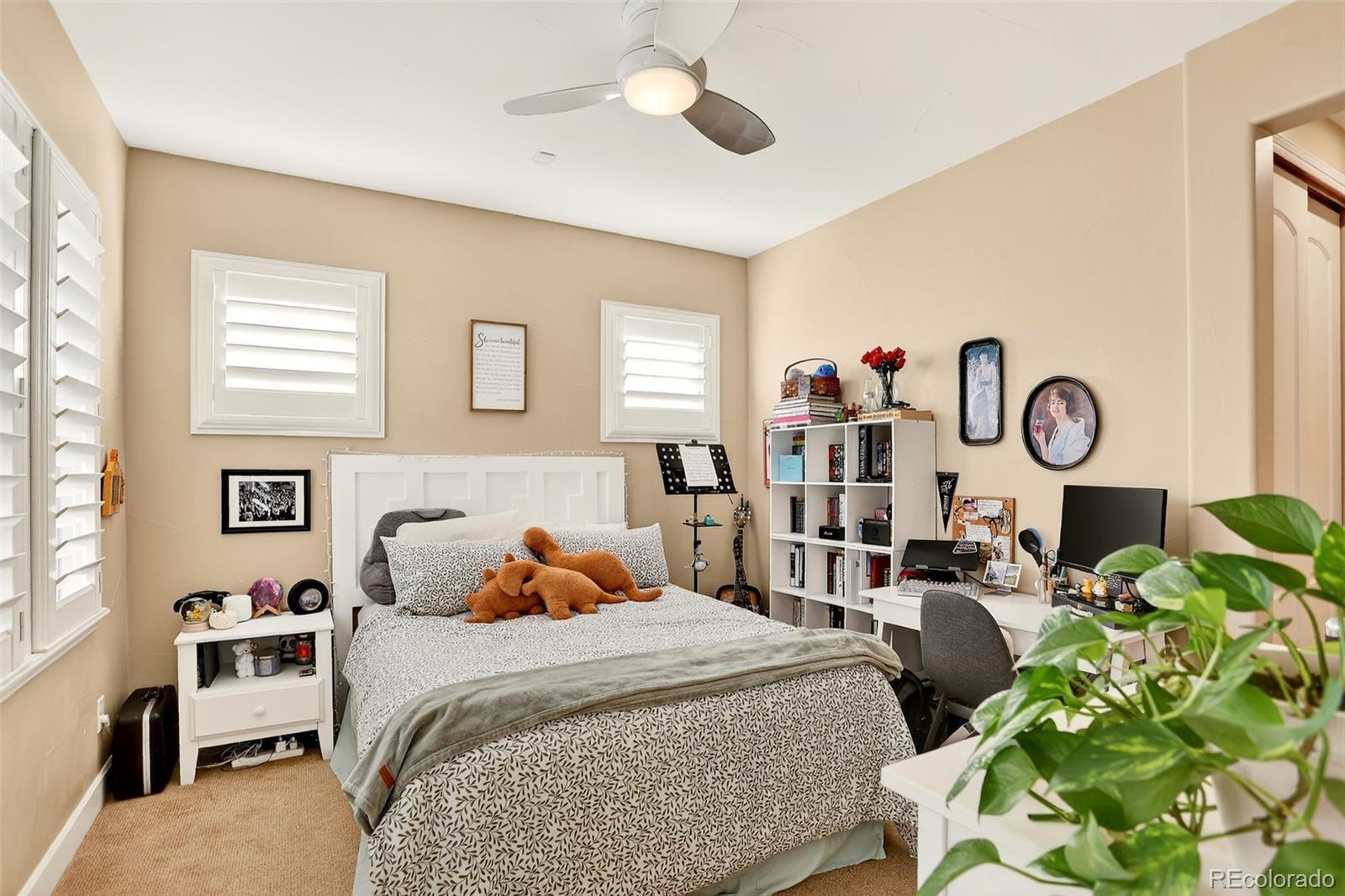10544 Soulmark Way Highlands Ranch, CO 80126 - Photo 30 of 50 a bedroom with a bed a dresser and chair