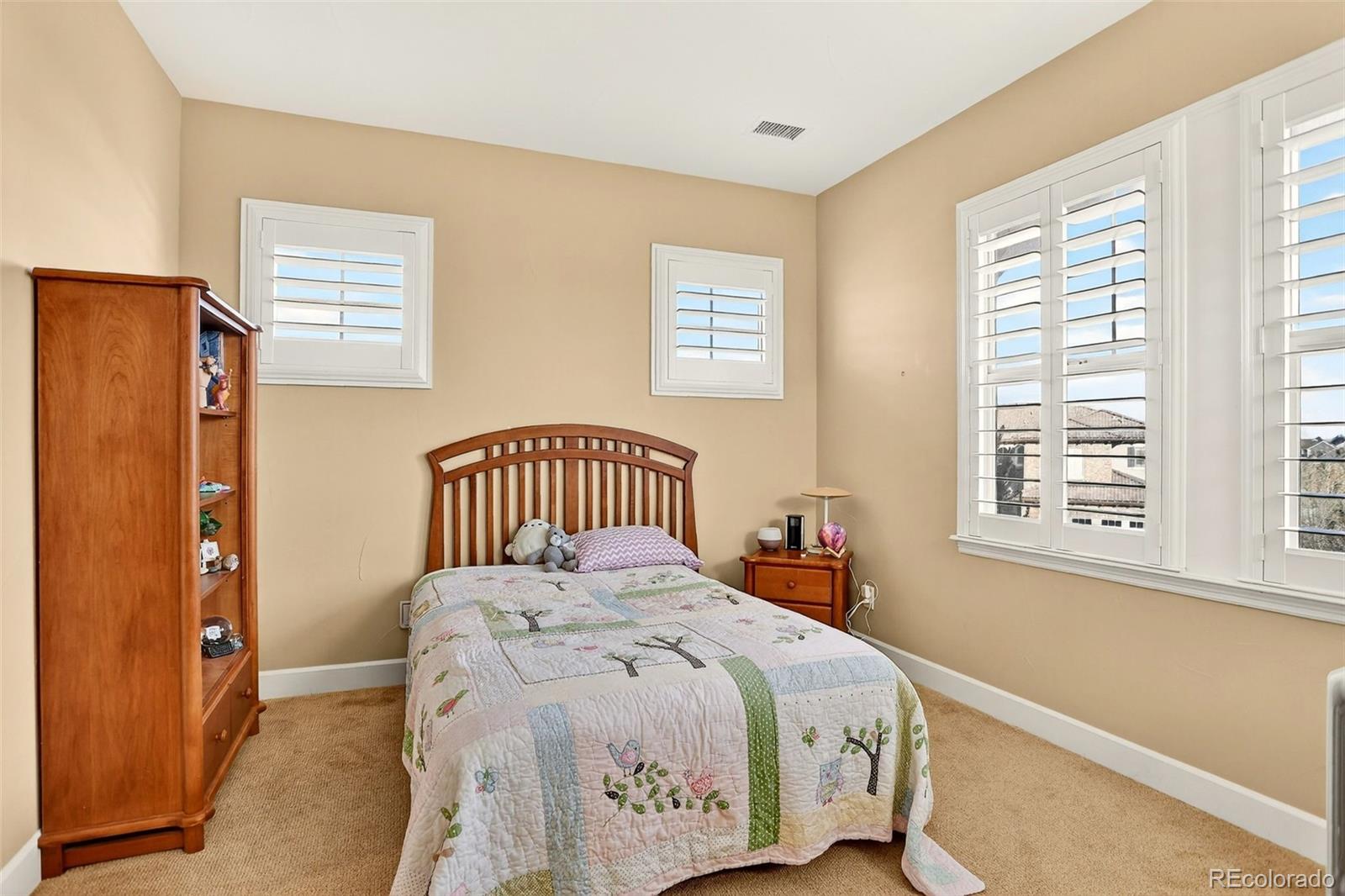 10544 Soulmark Way Highlands Ranch, CO 80126 - Photo 33 of 50 a bedroom with a bed and a window