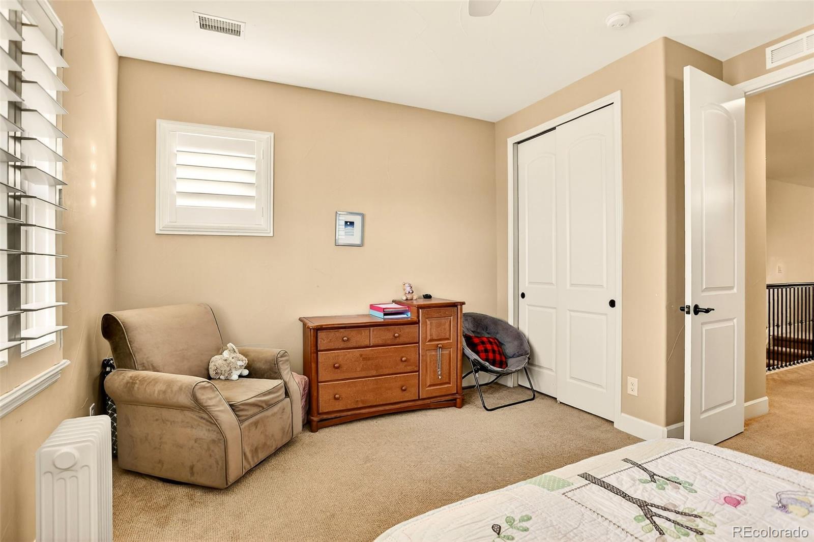 10544 Soulmark Way Highlands Ranch, CO 80126 - Photo 34 of 50 a bedroom with a bed and a window