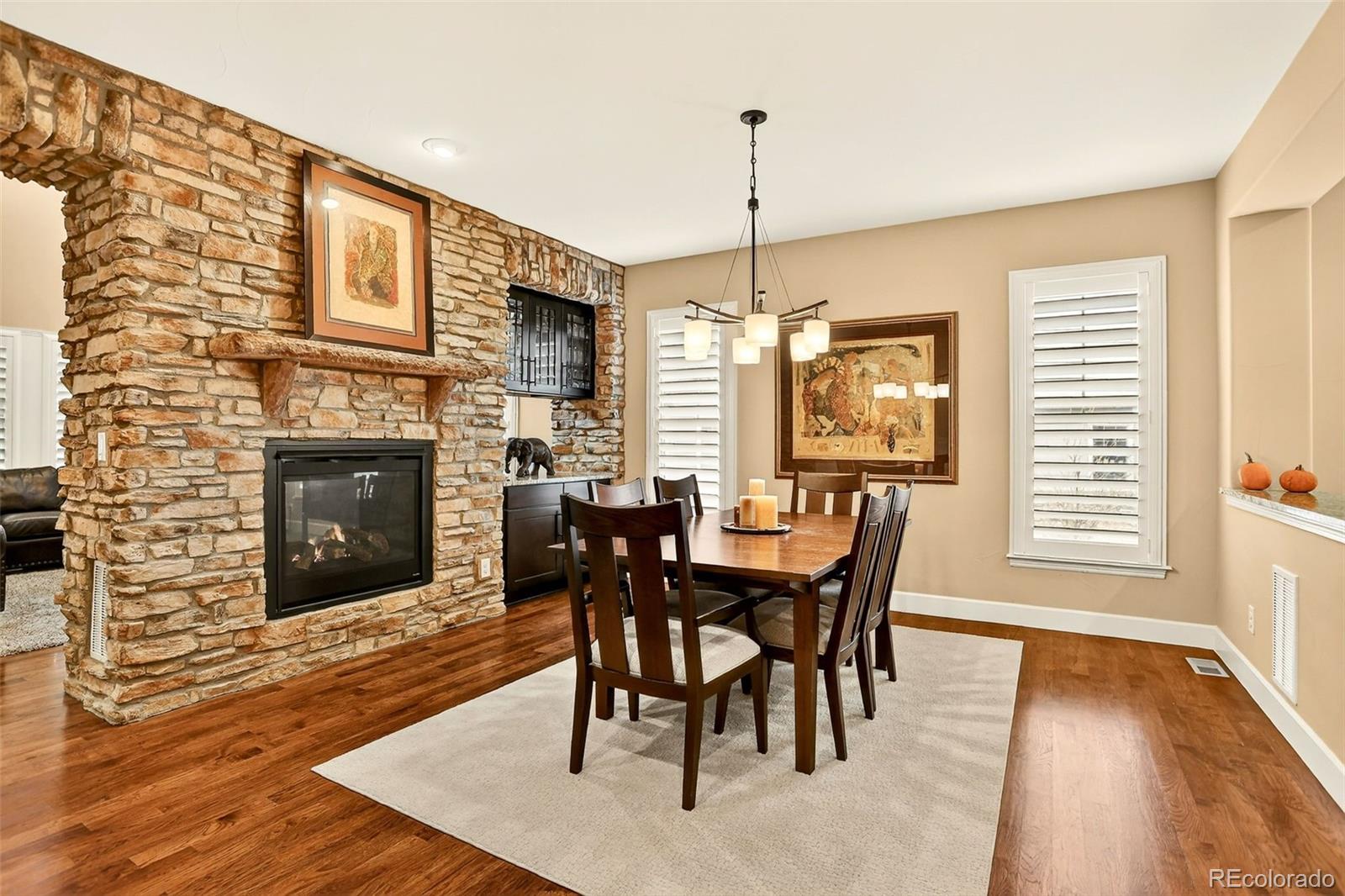 10544 Soulmark Way Highlands Ranch, CO 80126 - Photo 7 of 50 a view of a dining room with furniture window and wooden floor
