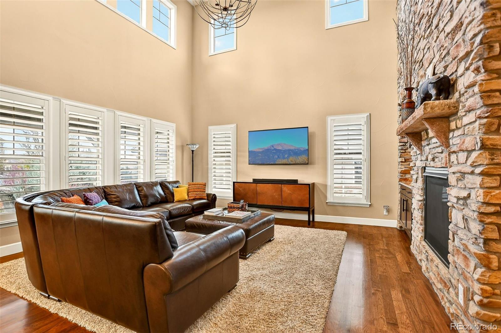 10544 Soulmark Way Highlands Ranch, CO 80126 - Photo 9 of 50 a living room with furniture and a fireplace