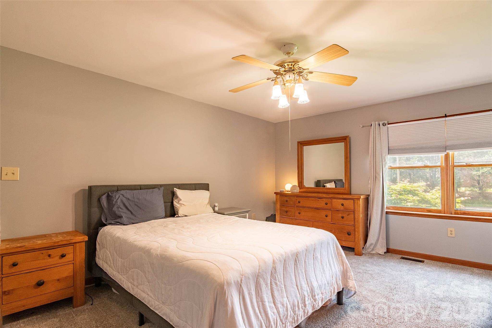 445 Old Caroleen Road Forest City, NC 28043 - Photo 12 of 28 a bedroom with a large bed and a chandelier