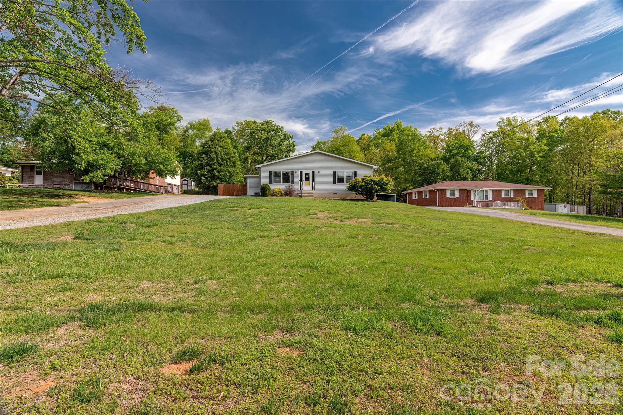 445 Old Caroleen Road Forest City, NC 28043 - Photo 25 of 28 a view of a house with a big yard and large trees