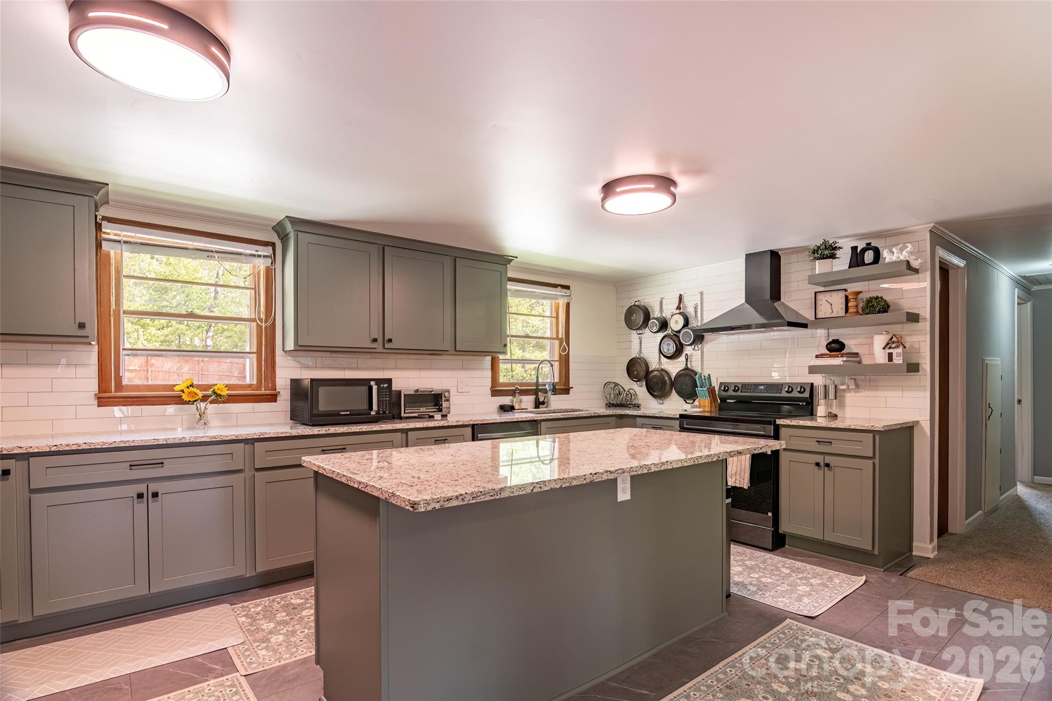 445 Old Caroleen Road Forest City, NC 28043 - Photo 6 of 28 a kitchen with stainless steel appliances granite countertop a sink stove and refrigerator