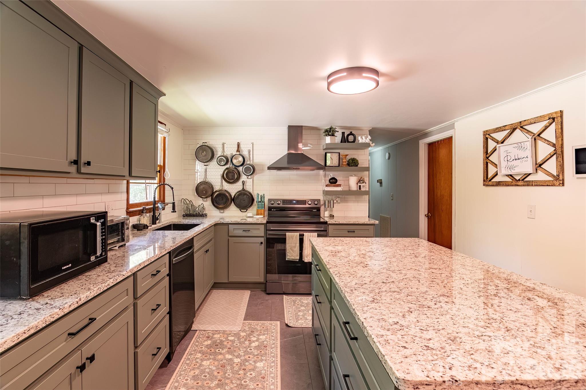445 Old Caroleen Road Forest City, NC 28043 - Photo 8 of 28 a kitchen with stainless steel appliances granite countertop a stove and a sink