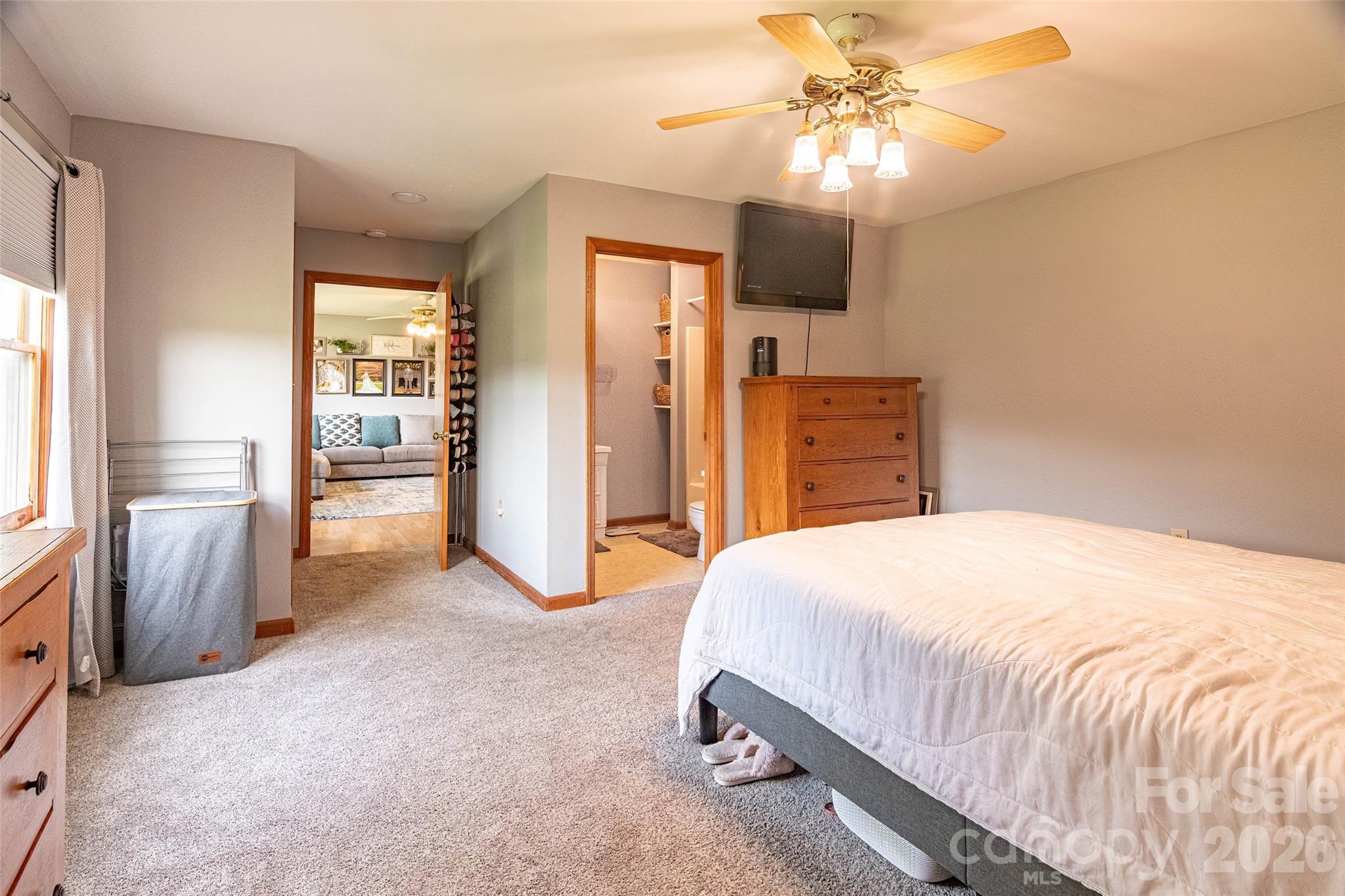 445 Old Caroleen Road Forest City, NC 28043 - Photo 9 of 28 a bedroom with a bed and a chandelier