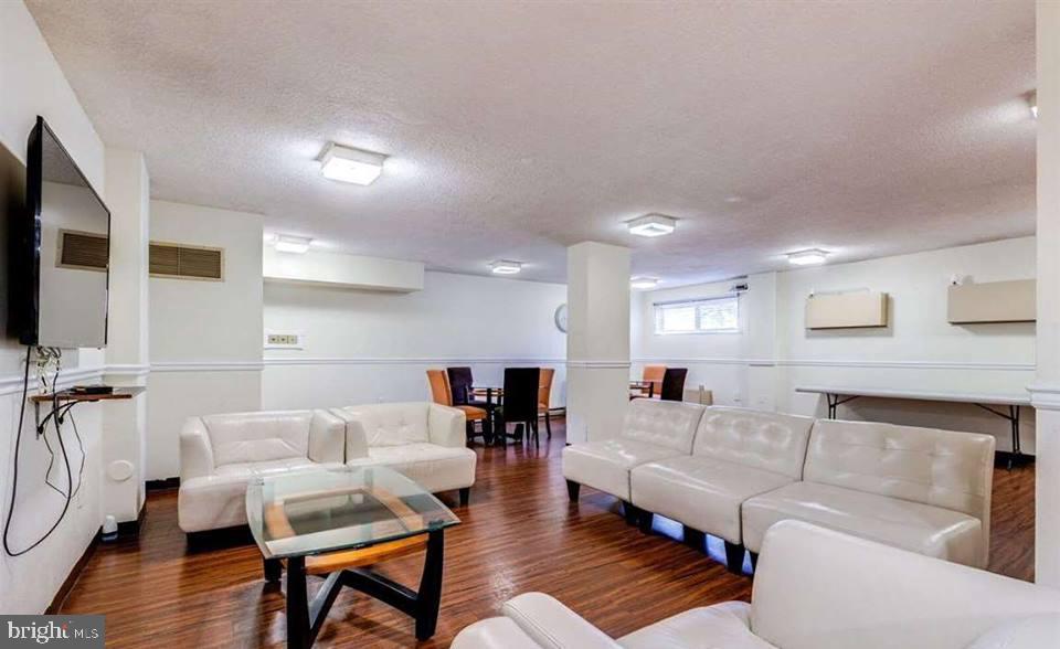 2059 Huntington Avenue, Unit 300 Alexandria, VA 22303 - Photo 16 of 30 a living room with furniture and a flat screen tv
