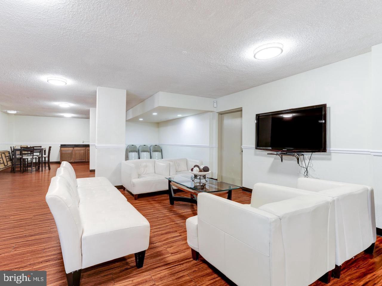 2059 Huntington Avenue, Unit 300 Alexandria, VA 22303 - Photo 18 of 30 a living room with furniture and a flat screen tv