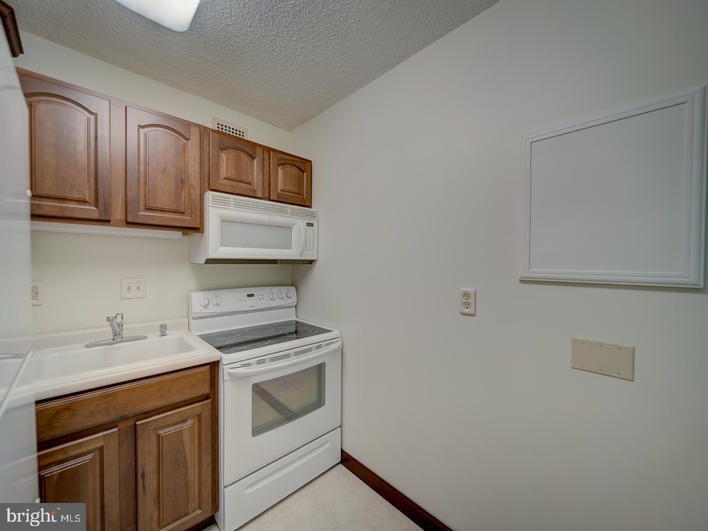 2059 Huntington Avenue, Unit 300 Alexandria, VA 22303 - Photo 8 of 30 a kitchen with cabinets appliances and a sink