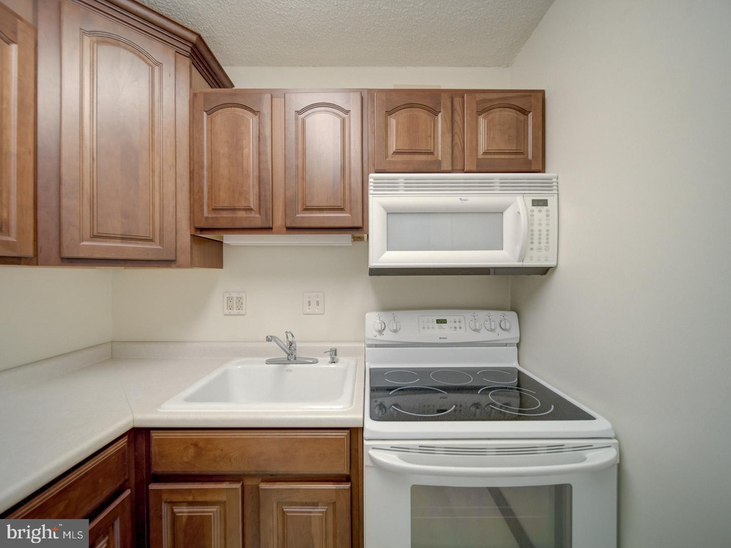 2059 Huntington Avenue, Unit 300 Alexandria, VA 22303 - Photo 10 of 30 a kitchen with sink a stove and cabinets