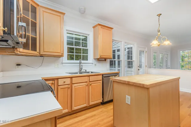 a kitchen with stainless steel appliances granite countertop a sink a stove and a refrigerator