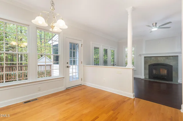 a view of an empty room with a fireplace and a large window