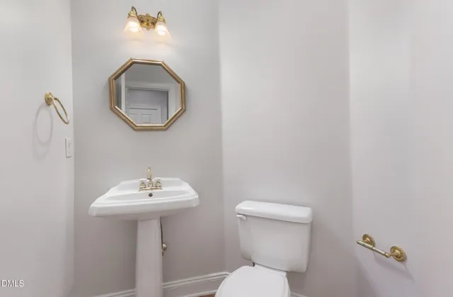 a bathroom with a sink a mirror and a toilet