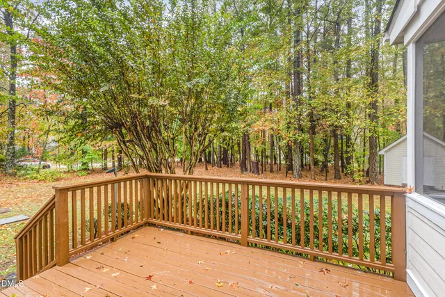 a view of backyard with deck and wooden floor