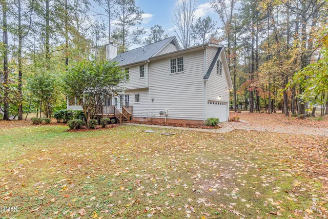 a view of a house with a yard and garage