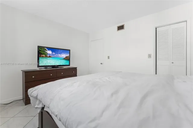 a bed room with a bed and a television