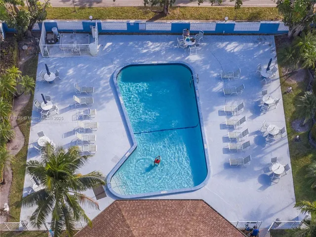 an aerial view of a house with a swimming pool