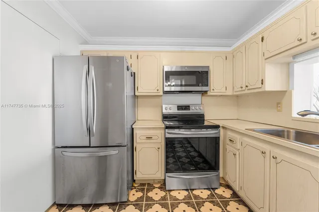 a kitchen with stainless steel appliances a refrigerator stove and microwave