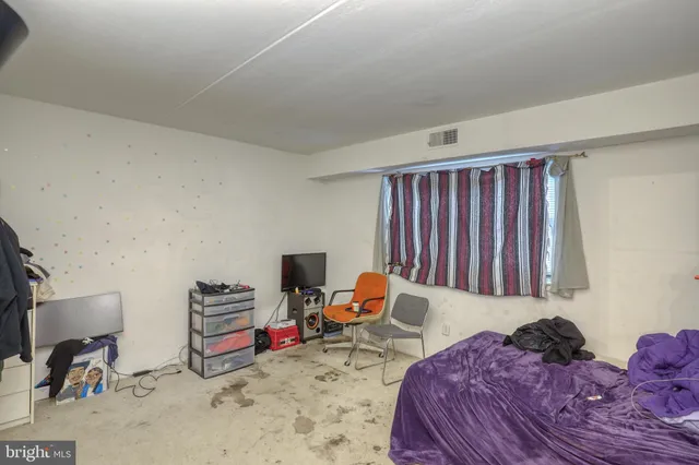 a bedroom with a bed and a couch