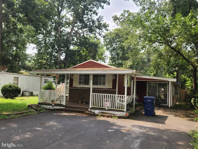 a view of a house with a patio and a yard