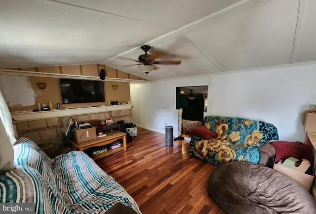 a bedroom with a bed wooden floor and dresser
