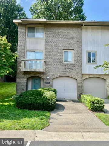 a front view of a house with plants