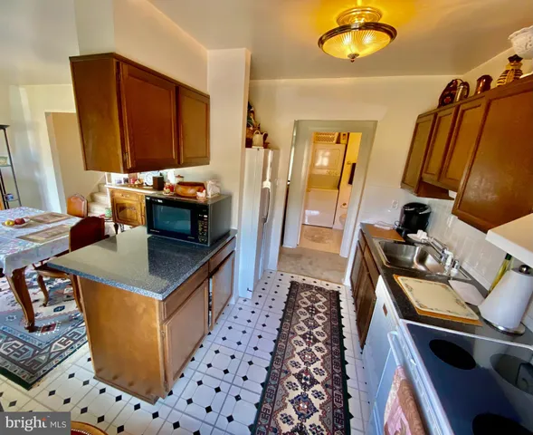 a kitchen with sink cabinets and appliances