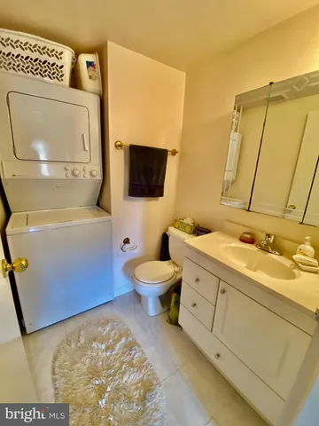a spacious bathroom with a toilet sink and mirror