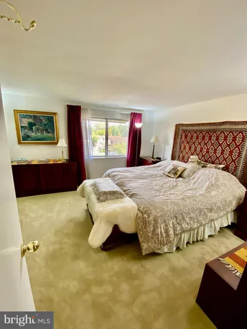 a bedroom with a bed and dresser