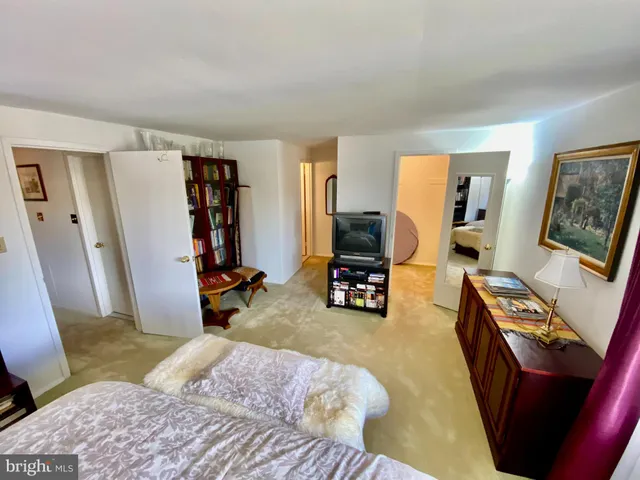 a bedroom with furniture and a flat screen tv