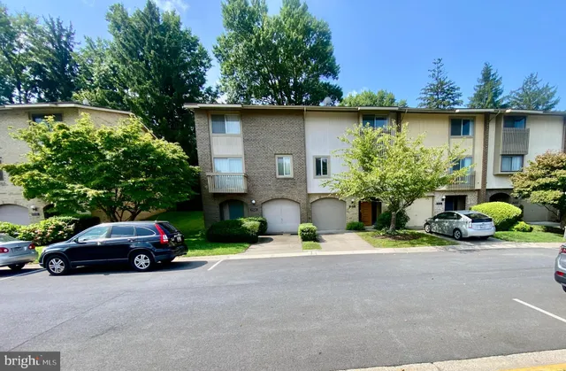a front view of a house with a yard and sitting area