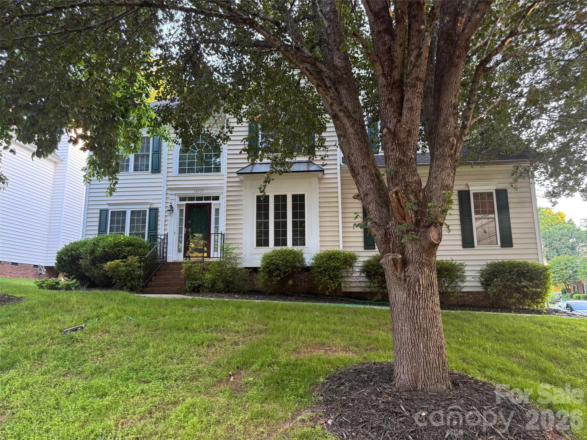 16905 Laureate Road, Unit 16 Huntersville, NC 28078 - Photo 3 of 38 a front view of a house with a yard and trees