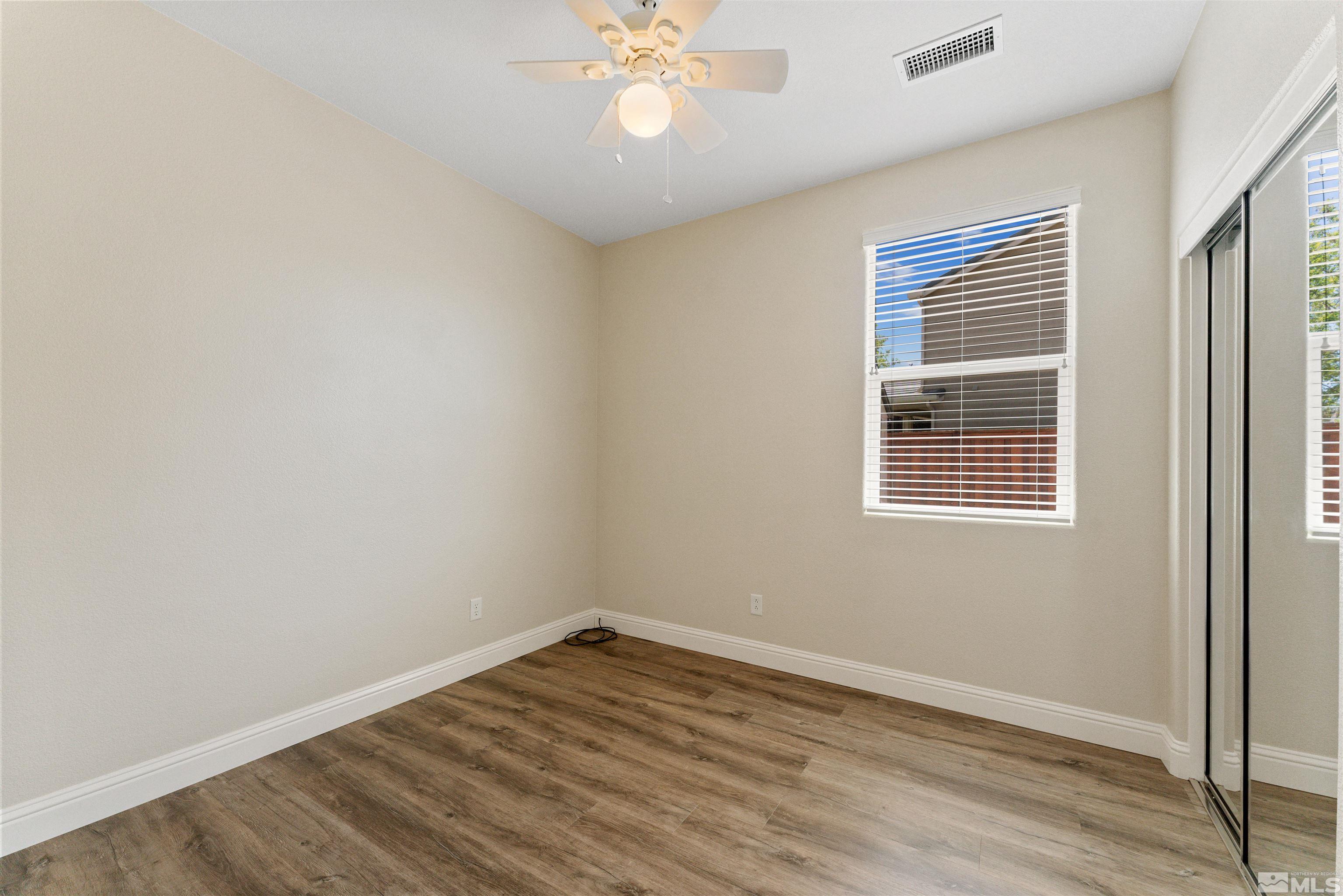 11475 Verazae Drive Reno, NV 89521 - Photo 27 of 40 wooden floor in an empty room with a window