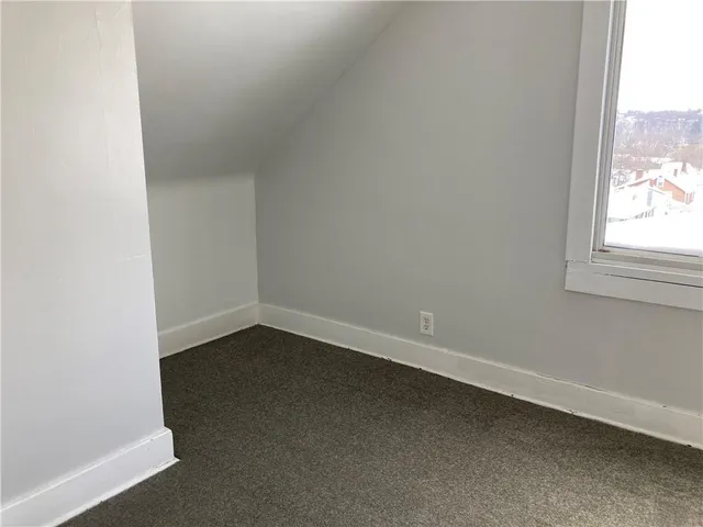 an empty room with a empty space and chandelier fan