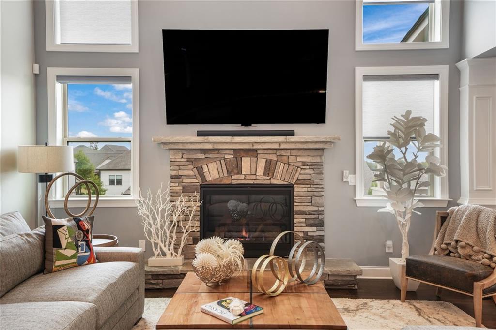 4450 Woodward Walk Lane Suwanee, GA 30024 - Photo 13 of 52 a living room with furniture fireplace and flat screen tv