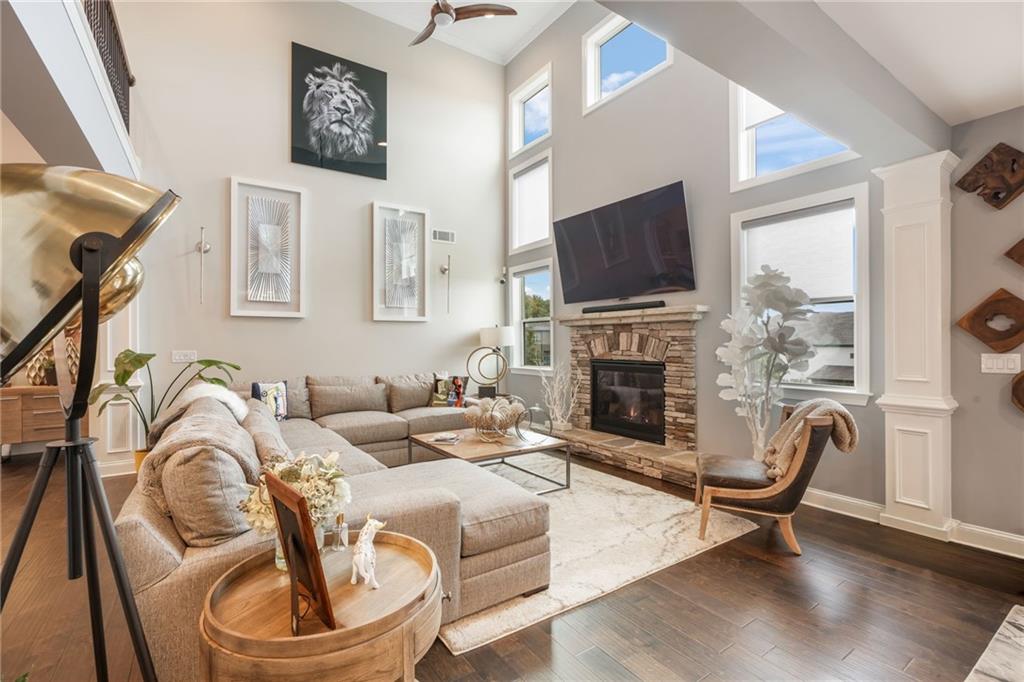 4450 Woodward Walk Lane Suwanee, GA 30024 - Photo 15 of 52 a living room with furniture a flat screen tv and a fireplace