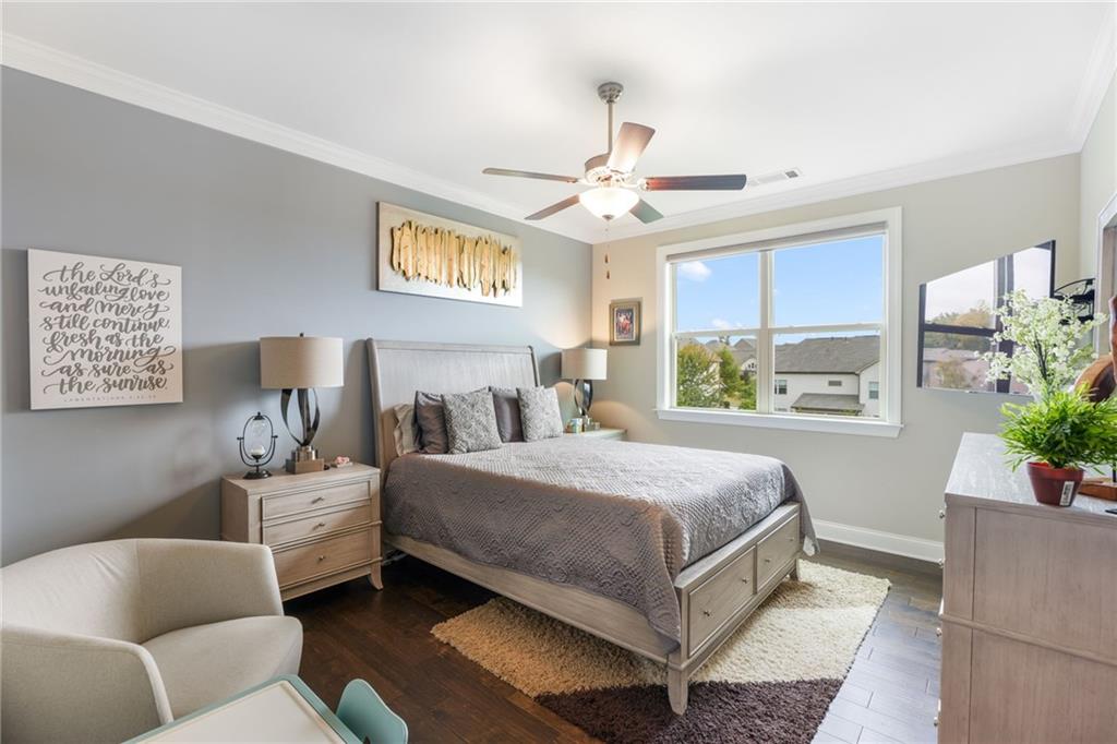 4450 Woodward Walk Lane Suwanee, GA 30024 - Photo 23 of 52 a bedroom with a bed couch and window
