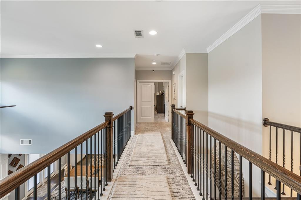 4450 Woodward Walk Lane Suwanee, GA 30024 - Photo 29 of 52 a view of a hallway with wooden floor and staircase