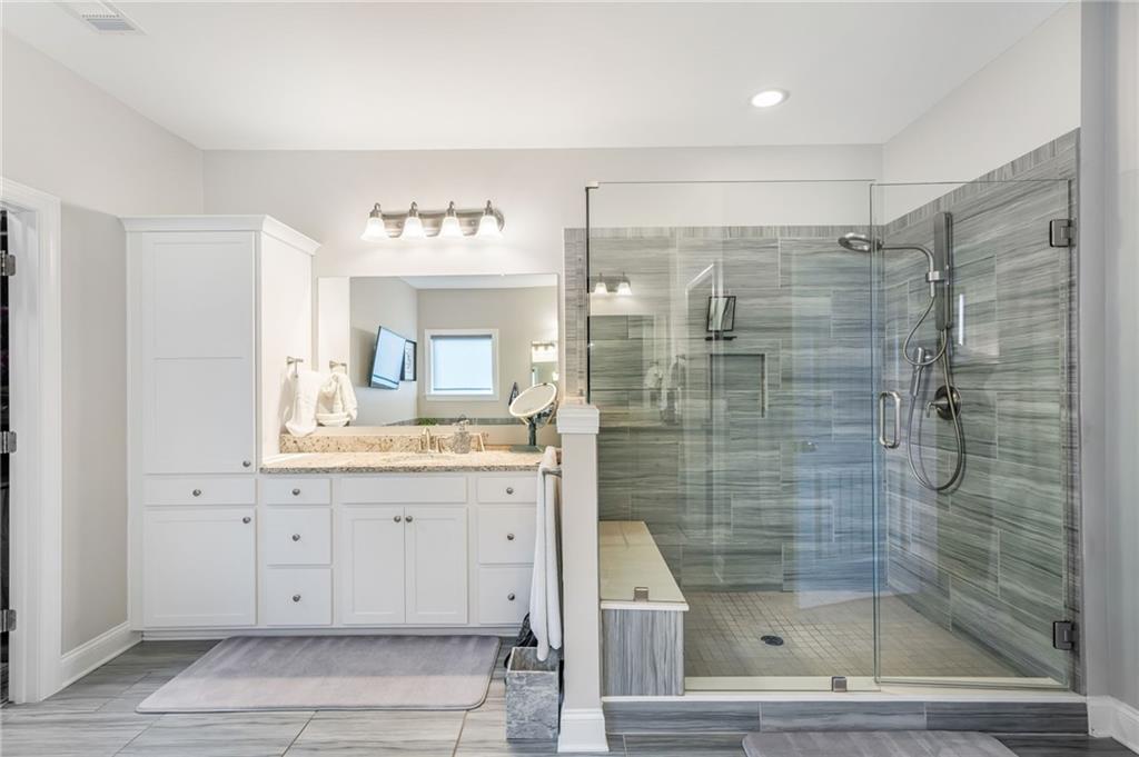 4450 Woodward Walk Lane Suwanee, GA 30024 - Photo 33 of 52 a bathroom with a shower and a sink