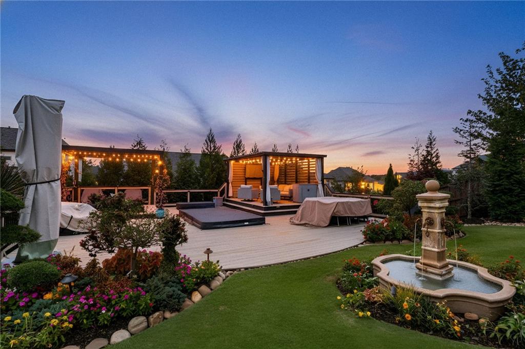 4450 Woodward Walk Lane Suwanee, GA 30024 - Photo 4 of 52 a view of a backyard with couches plants and large tree