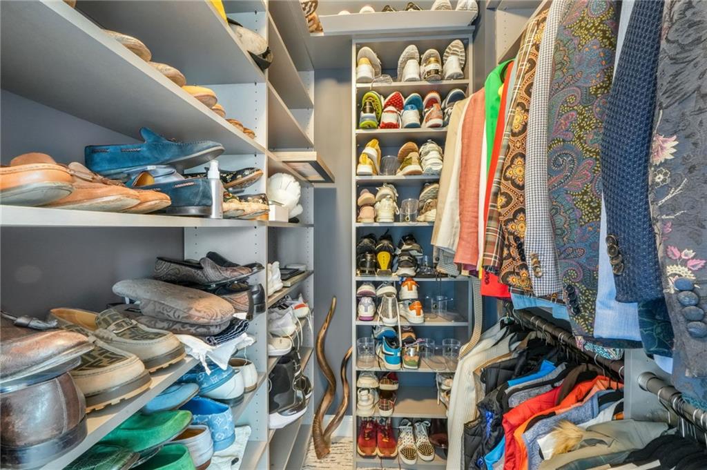 4450 Woodward Walk Lane Suwanee, GA 30024 - Photo 41 of 52 a view of walk in closet with clothes and shoes