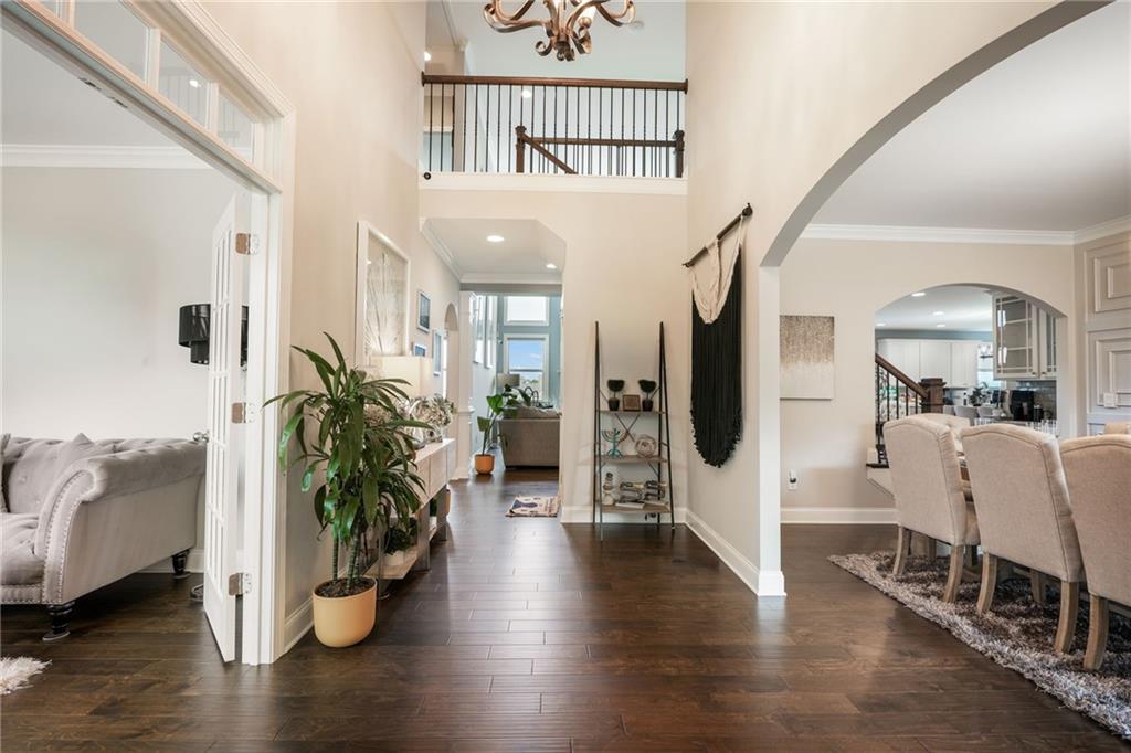 4450 Woodward Walk Lane Suwanee, GA 30024 - Photo 7 of 52 a view of an entryway with wooden floor and a potted plant