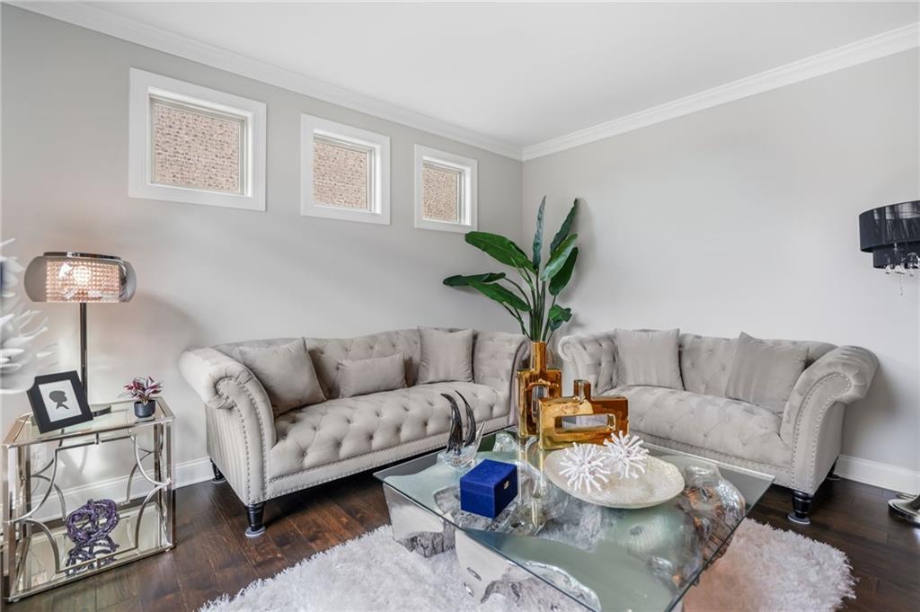 4450 Woodward Walk Lane Suwanee, GA 30024 - Photo 9 of 52 a living room with furniture potted plant and a window