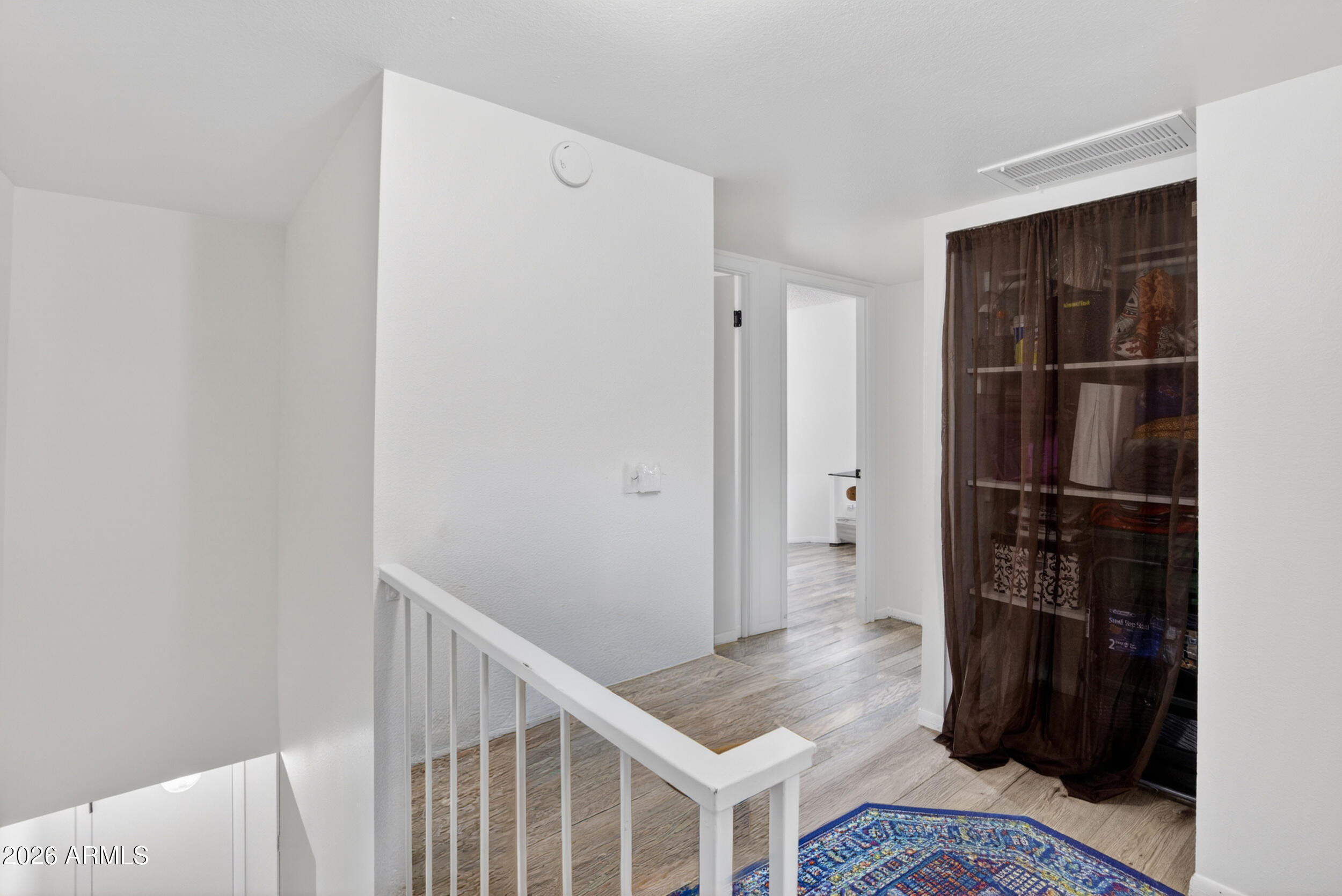 5007 South Terrace Road Tempe, AZ 85282 - Photo 15 of 33 a view of hallway with walk in closet and wooden floor