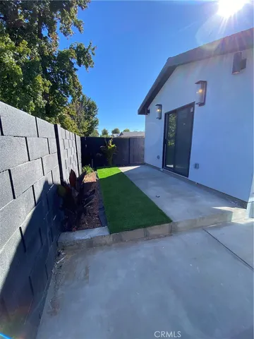 a view of backyard with outdoor seating and green space